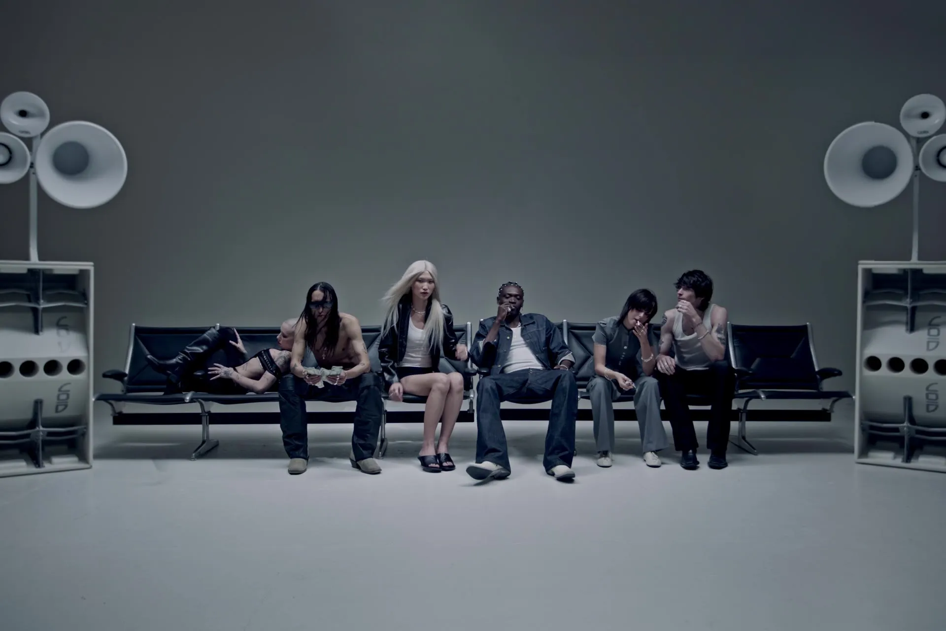 Models on a bench between two Void stacks