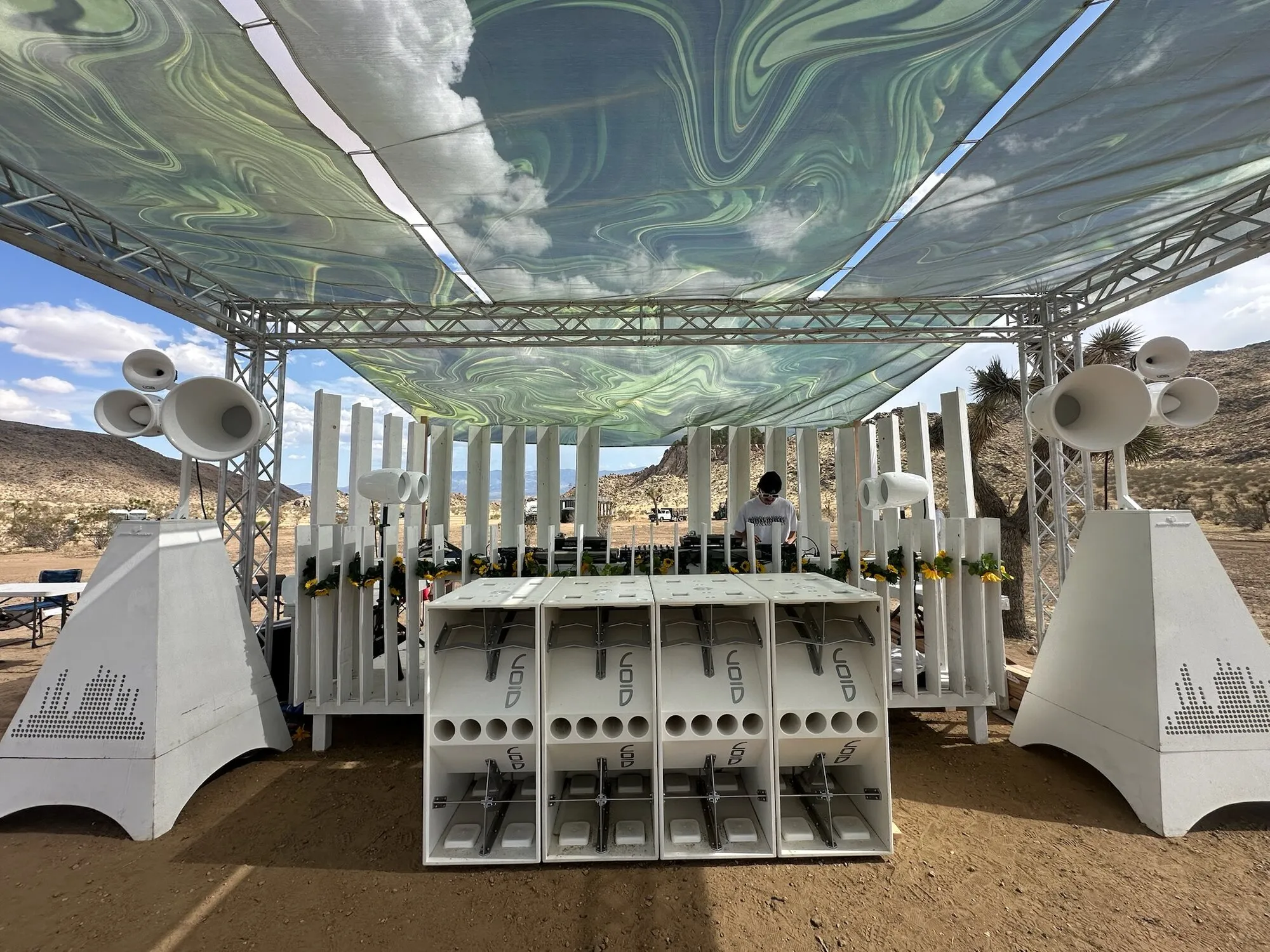 White Void Acoustics 4x4 stack under a festival canopy in the desert at NZT Fest