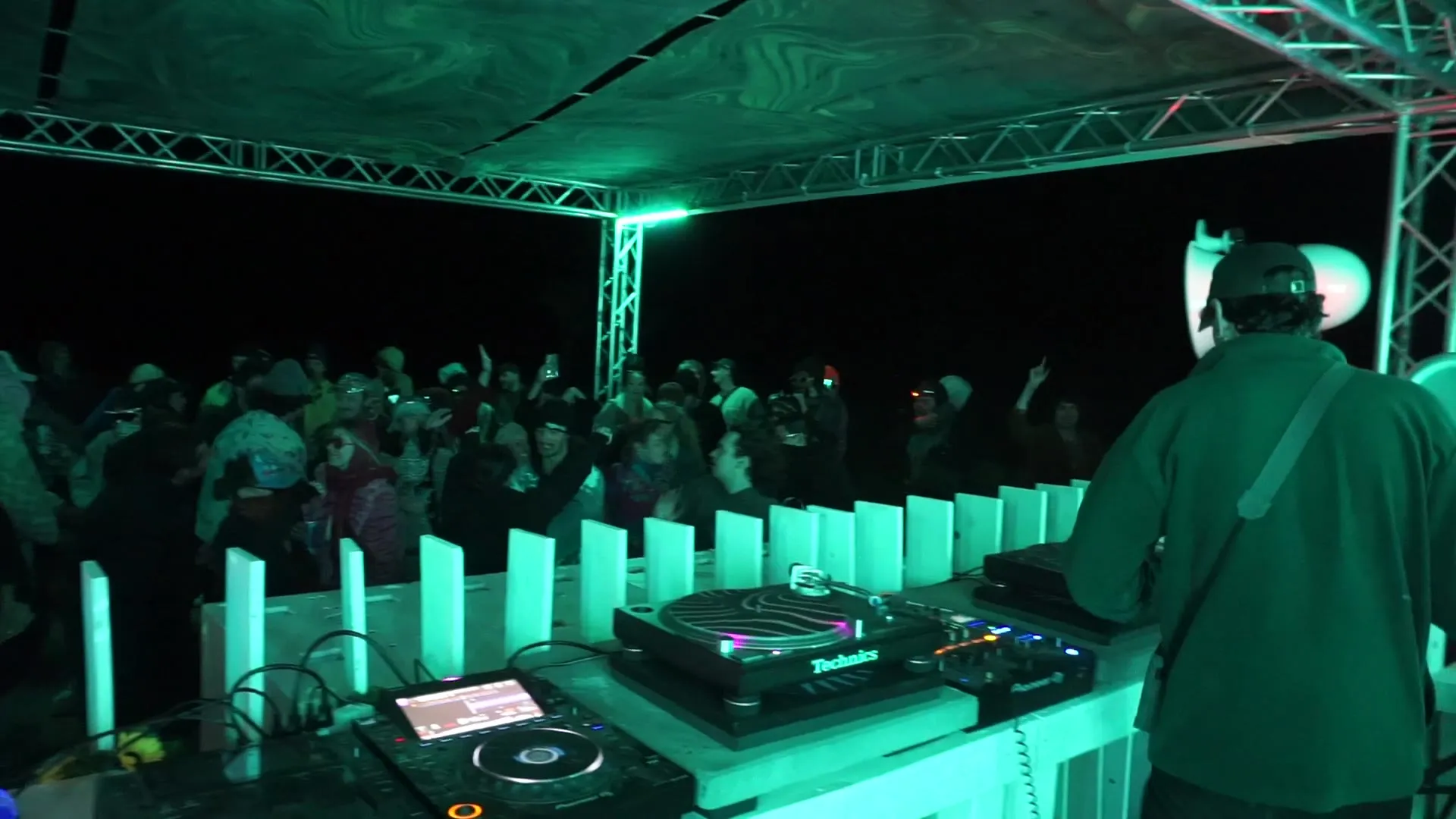DJ booth lit teal at night