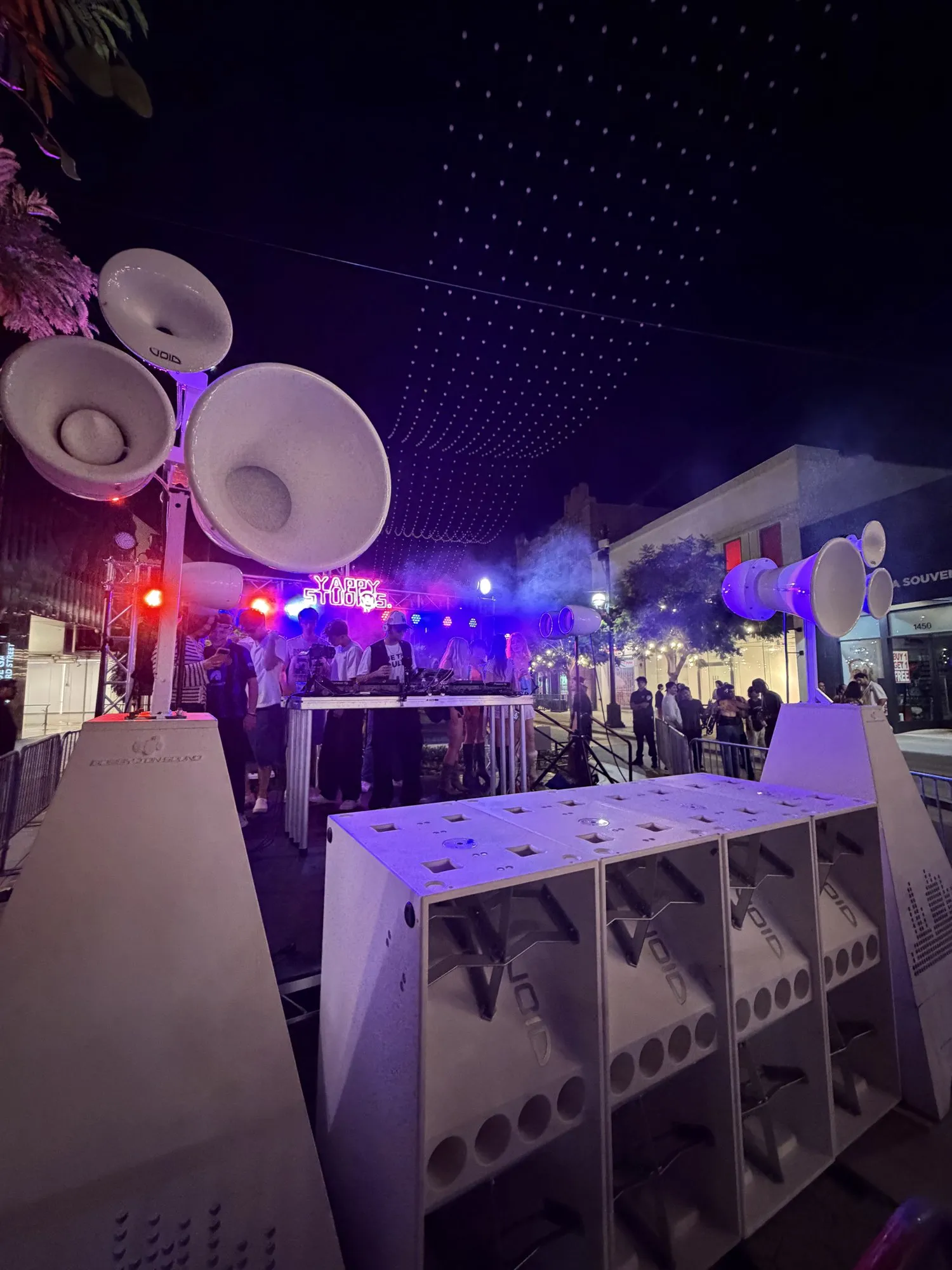Crowd under string lights at night