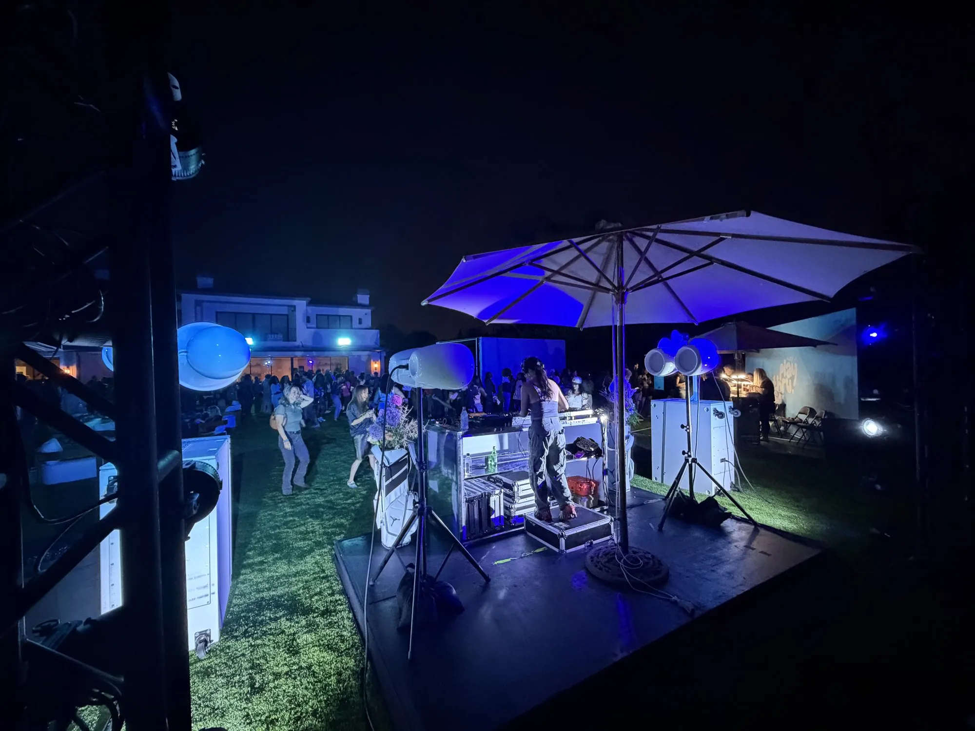 Stage under a lit umbrella at night