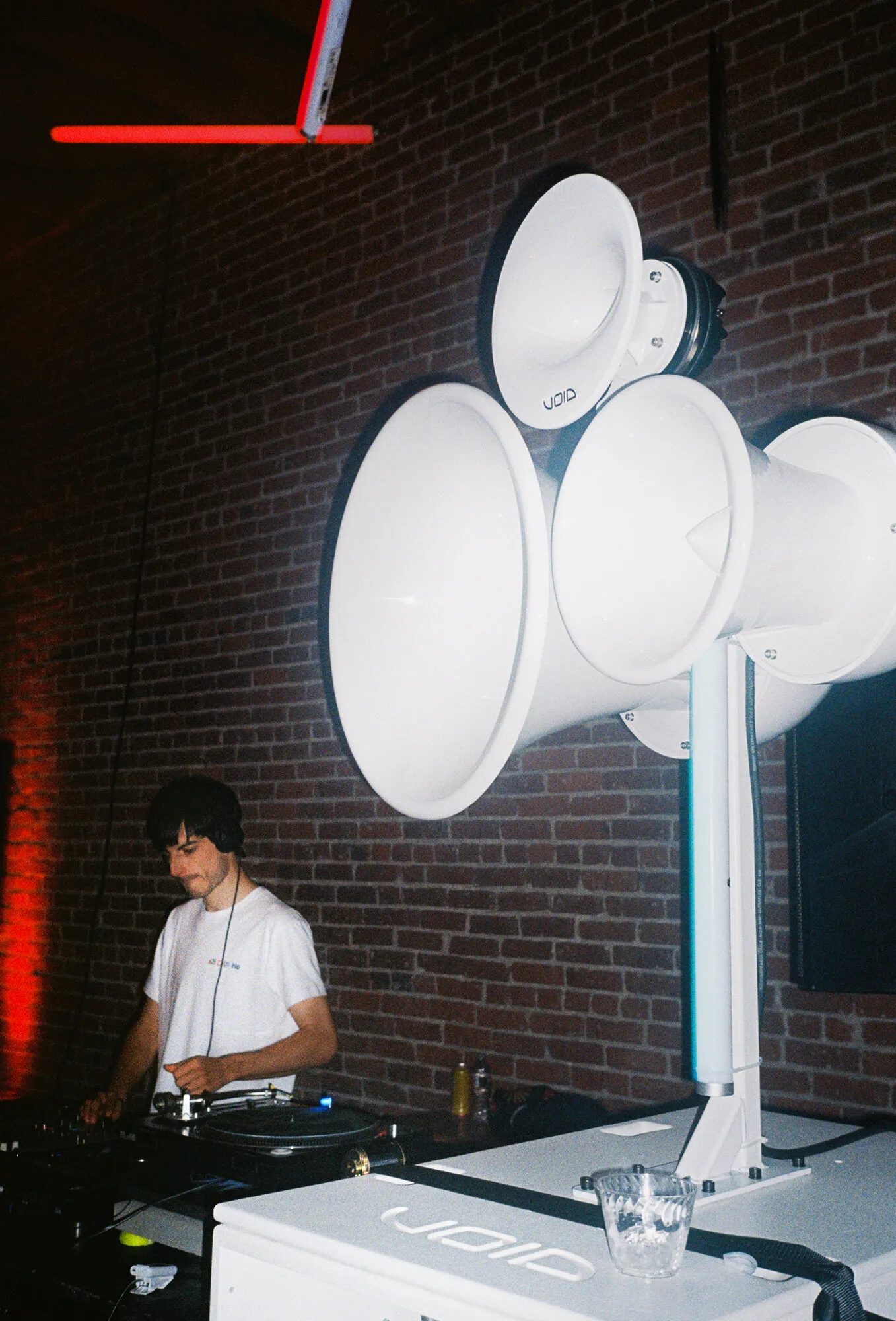 DJ playing in front of a tall white Void Air Motion stack