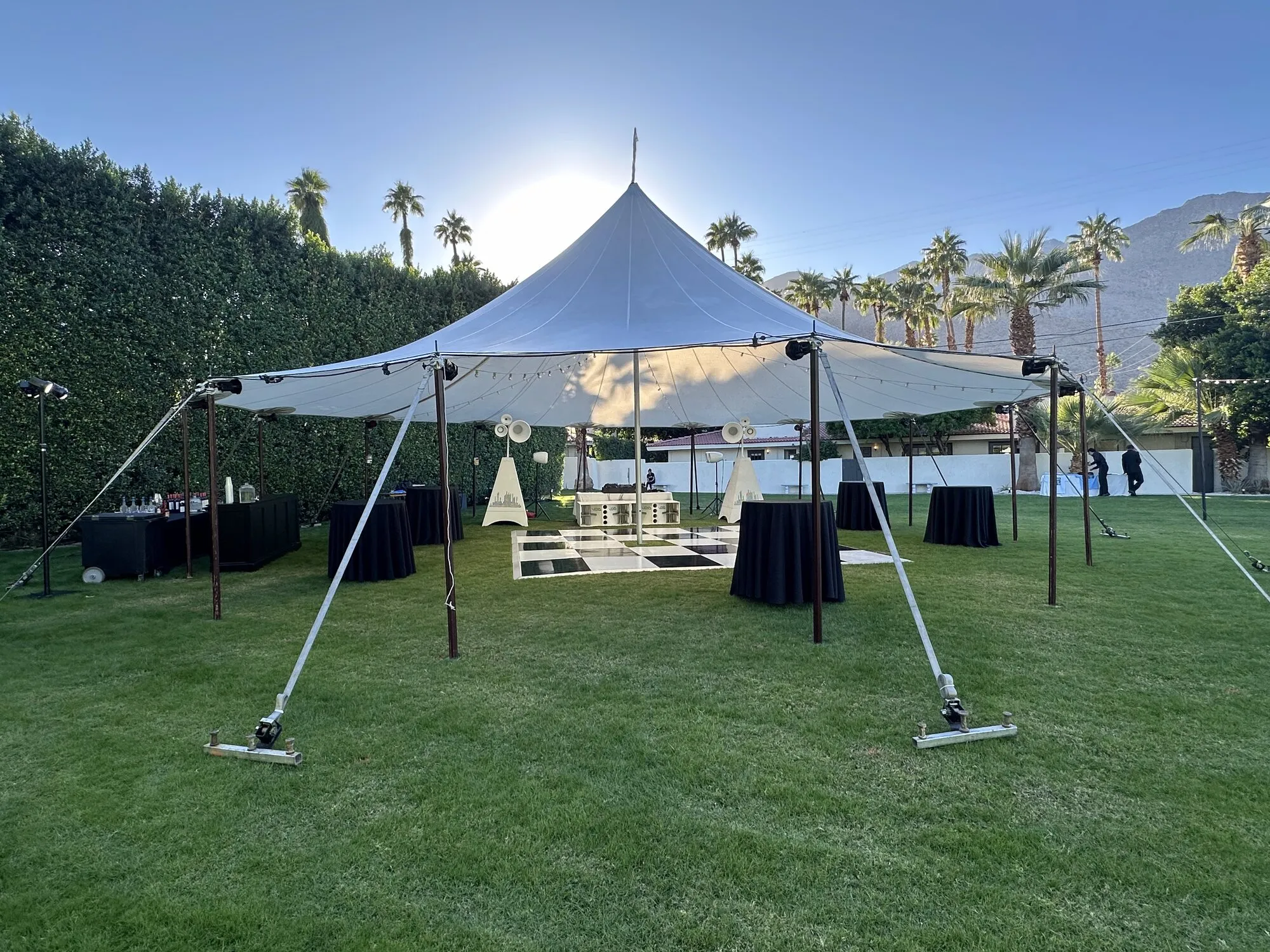 Tent and dance floor setup in daylight